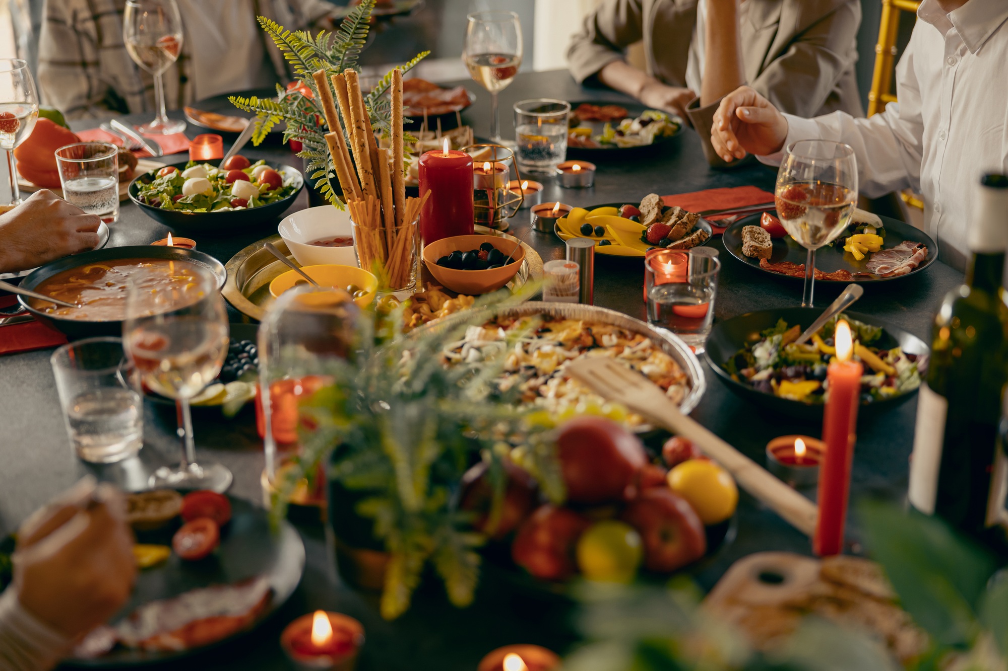 Cozy holiday table setting with different delicious food and beverages ready for friends home party